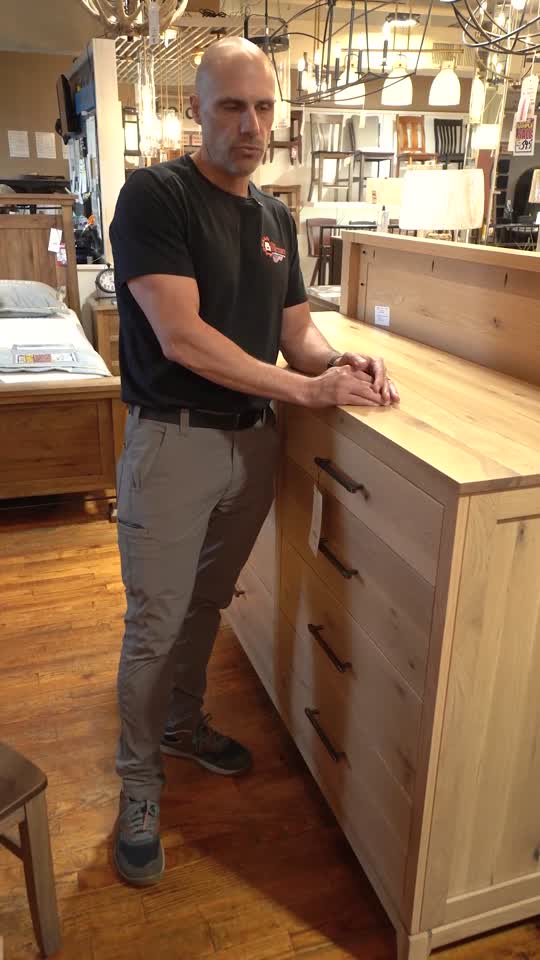 Cory inspecting an open dresser drawer at The Factory showroom
